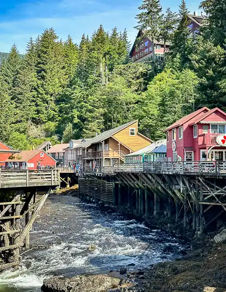 Creek Street in Ketchikan, Alaska, with colorful buildings, water, and trees during an easy Alaska cruise port day.