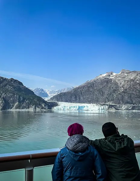 Passengers watching a glacier from the deck during a Glacier Bay scenic cruising day on an Alaska cruise.