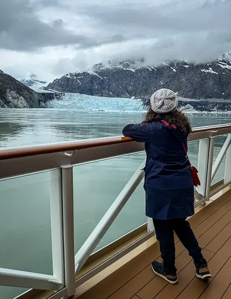 Kathy bundled up on the cruise ship deck while viewing Glacier Bay during an Alaska cruise scenic cruising day.