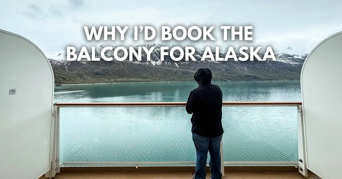 featured bog image: Person (hubby) standing on an Alaska cruise balcony overlooking snow-covered mountains and calm water, with overlay text reading “Why I’d Book the Balcony for Alaska.”