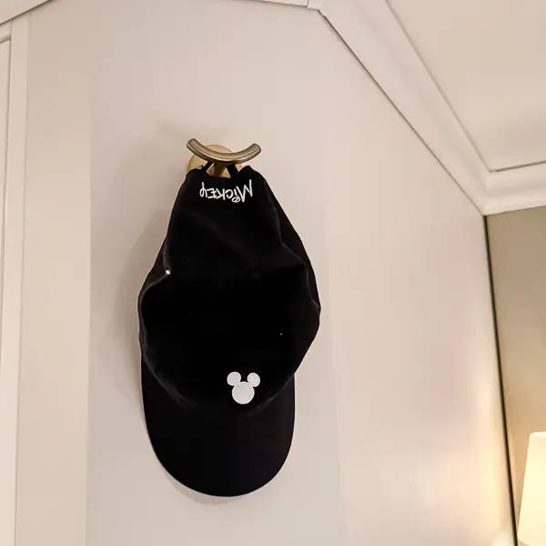 Black Mickey Mouse baseball cap hanging in a Disney cruise stateroom