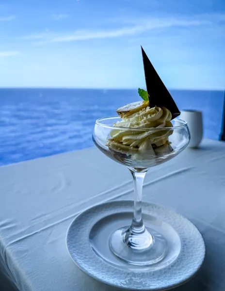 Banana Banoffee dessert served in Norwegian Aqua The Haven Restaurant with ocean views.