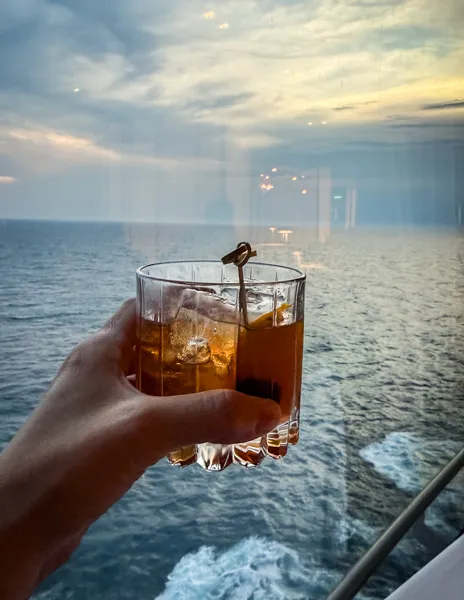 Buffalo Trace Old Fashioned from The Haven Bar on Norwegian Aqua with ocean views at sunset.