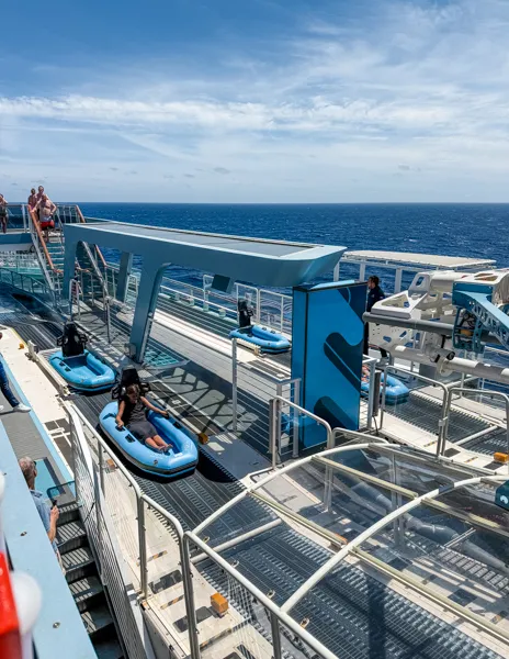 Aqua Slidecoaster on Norwegian Aqua with guests riding the slide over the ocean.