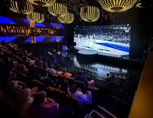 Knicks playoff game shown in the Norwegian Aqua theater with passengers watching from the seats.
