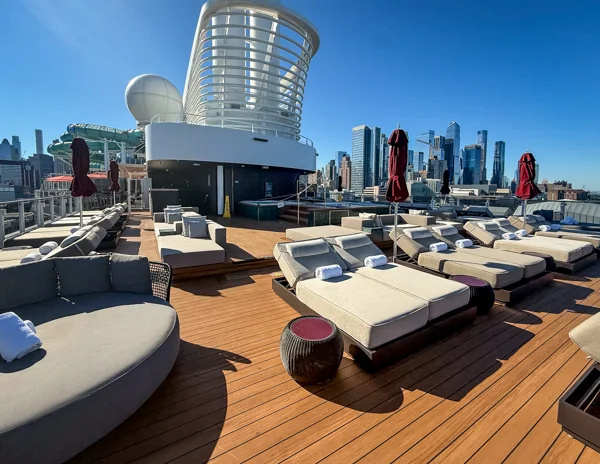 Norwegian Aqua Haven adults-only outdoor deck with loungers and New York City skyline views.