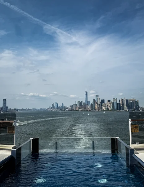 Norwegian Aqua The Haven infinity pool during sailaway from New York City with skyline views