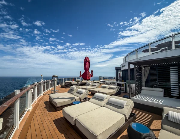 Norwegian Aqua The Haven pool deck with loungers, cabanas, and ocean views.