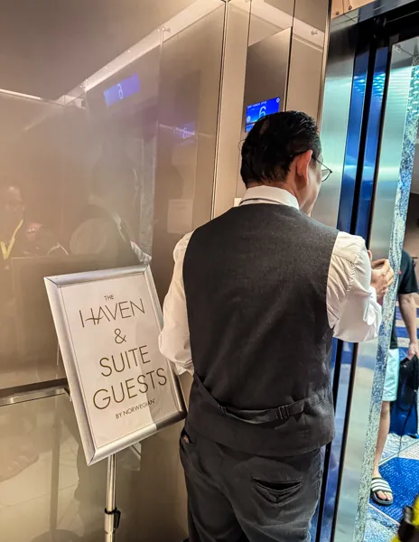 Norwegian Aqua The Haven and suite guests priority escort at the port with crew member by the elevators.