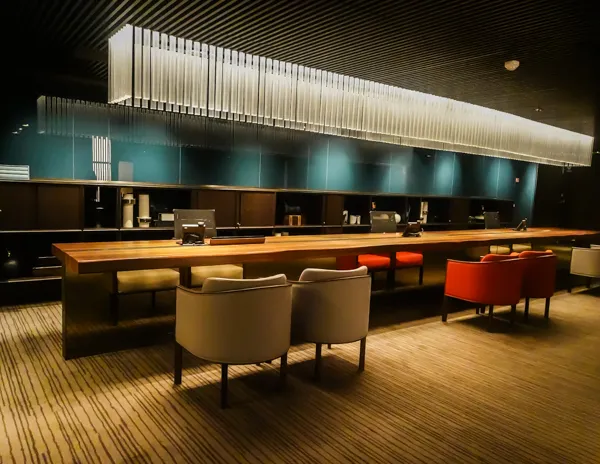 Norwegian Aqua The Haven concierge desk with seating and modern lighting.