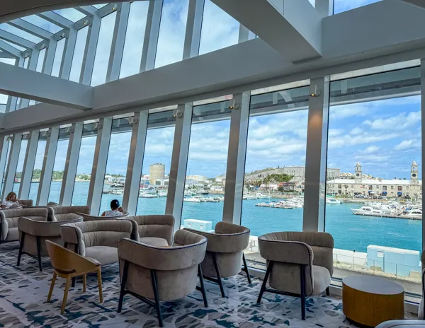 Seating area behind Starbucks on Norwegian Aqua with large windows and waterfront views.
