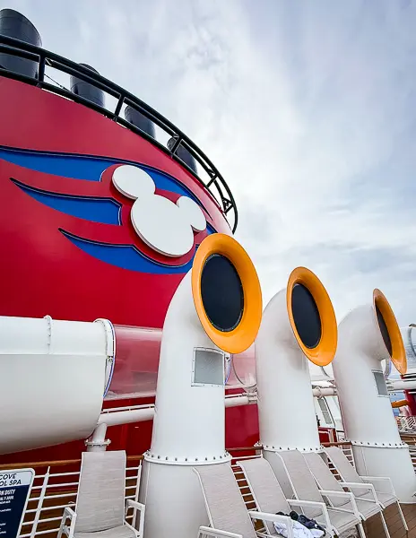 Disney Cruise Line ship horns beside the red funnel with the Mickey Mouse logo.