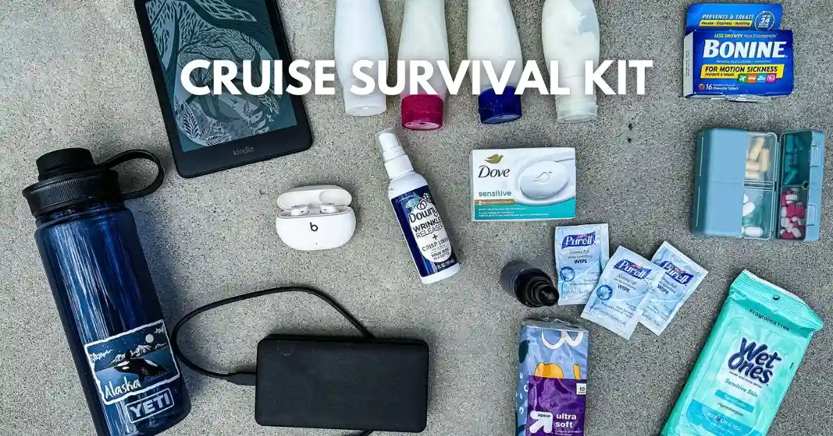 Cruise survival kit essentials laid out with a Kindle, reusable water bottle, portable charger, toiletries, seasickness medicine, medications, wrinkle release spray, sanitizing wipes, and earbuds.