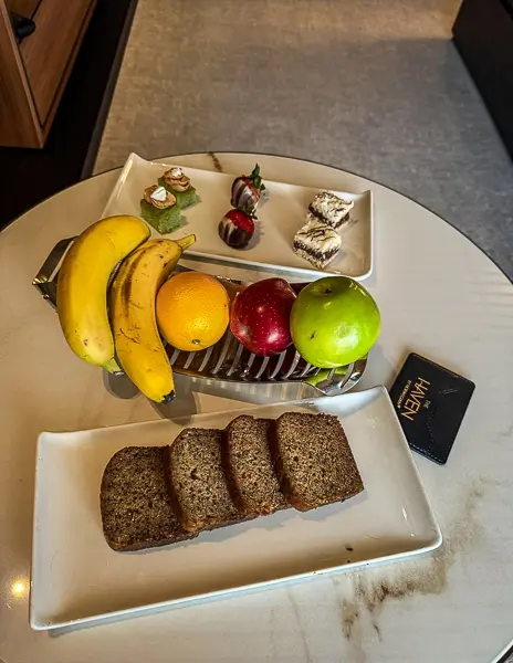 NCL Haven daily snacks with banana bread, fresh fruit, and small sweets delivered to the suite by the butler.