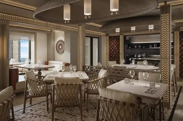 Rendering of Tamara, Norwegian Aura’s new Indian specialty restaurant, with dining tables and an open-view kitchen.