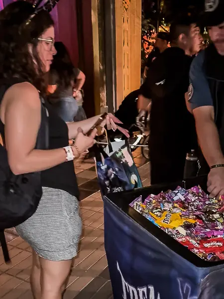 Collecting candy from a treat station at Oogie Boogie Bash in Disney California Adventure.