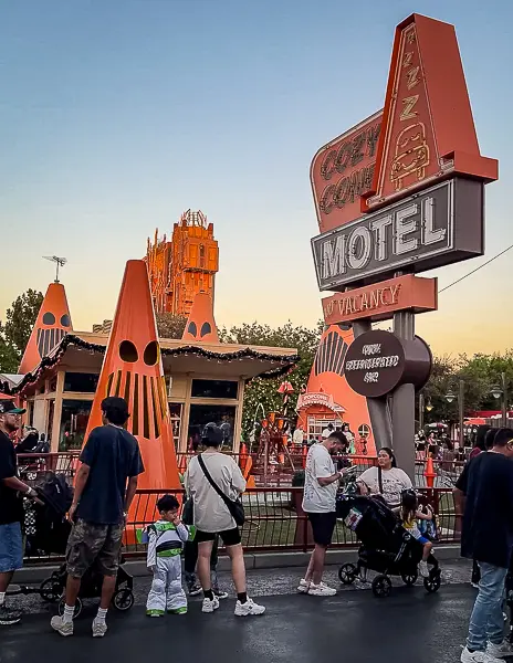 Halloween decorations in Cars Land at Disney California Adventure, featuring the Cozy Cone Motel's pumpkin-themed cones and Halloween signage.
