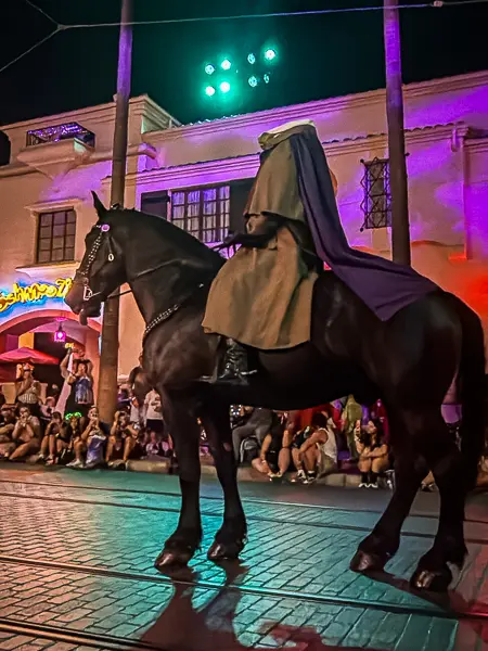 The Headless Horseman riding a black horse along the parade route at Oogie Boogie Bash in Disney California Adventure.