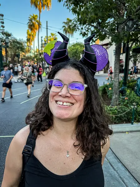 Wearing purple and green Maleficent Mickey ears and a black tank top at Oogie Boogie Bash in Disney California Adventure.
