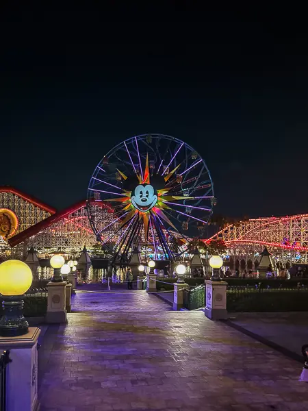 Pixar Pier at Disney California Adventure during Oogie Boogie Bash, with the illuminated Pixar Pal-A-Round Ferris wheel, Incredicoaster, and a nearly empty walkway at night.
