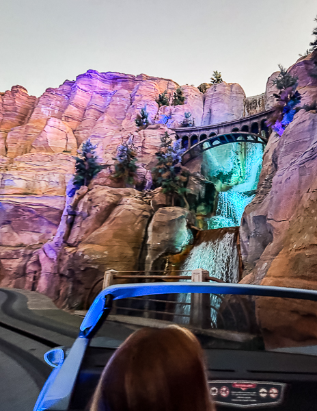 View of the rocky canyon, bridge, and waterfall from Radiator Springs Racers in Cars Land at Disney California Adventure.