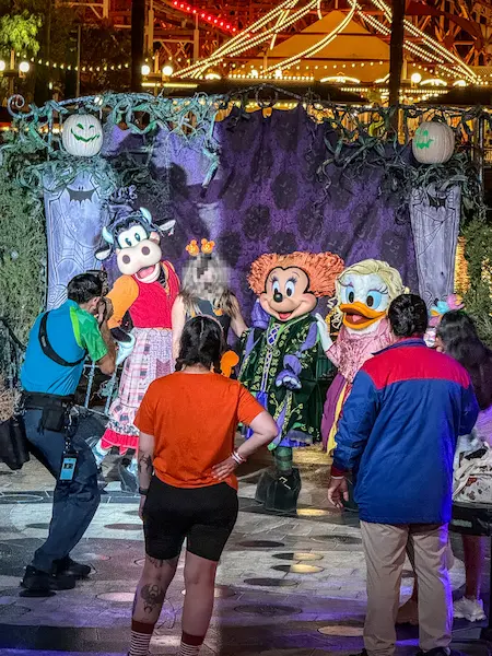 Minnie Mouse, Daisy Duck, and Clarabelle Cow dressed as the Sanderson Sisters from Hocus Pocus during a character meet-and-greet at Oogie Boogie Bash.