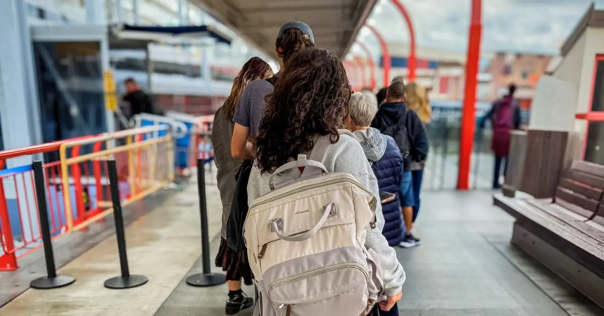 Kathy Ava wearing her cruise carry-on backpack while boarding a cruise ship on embarkation day.